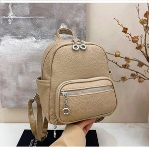 Chic beige faux leather backpack for women with pebbled texture and dual zippers