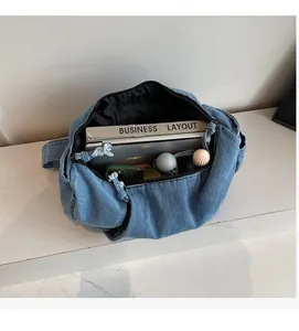 Spacious interior of blue denim tote bag showing laptop and daily essentials