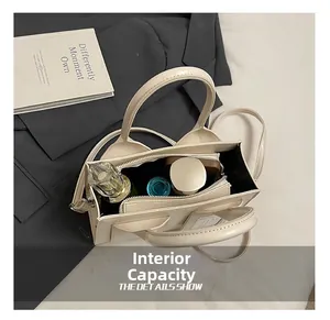 Spacious interior of beige bucket bag showing zip pocket and large storage capacity