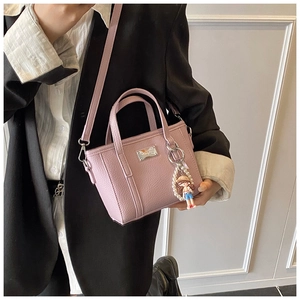 Detail of light purple lychee texture tote bag with pearl doll charm and silver logo