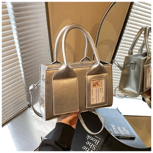 Detailed macro view of the silver mirror bucket bag featuring a transparent card slot detail