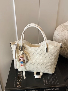 Chic beige quilted tote bag with woven texture, round handles and cute cartoon keychain
