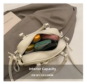Internal capacity of the cream leather Boston bag showing space for daily essentials