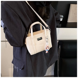 Cream white mini crossbody bag with litchi texture PU leather and cute charms decoration