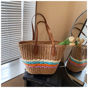 Détail du sac cabas en paille tissé main avec rayures colorées et anses en cuir