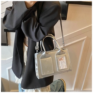 Detail of silver rectangular crossbody bag with card slot and adjustable strap