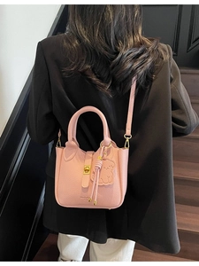 Pink lychee grain leather bucket bag with top handle and gold clasp for women