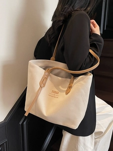 Minimalist off-white canvas tote bag with brown leather straps and SOBAG text print
