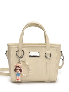 Minimalist cream leather bucket bag with top handles and cartoon pearl charm accessory