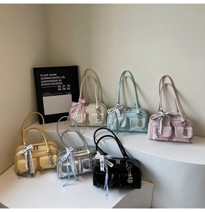 Detail of Boston bags with bow ribbons and heart charms in six various colors
