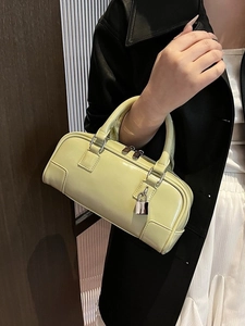 Chic light green leather boston bag with metallic lock detail and stylish top handles
