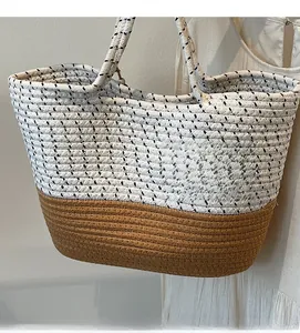 Close-up of the two-tone straw woven tote bag with durable braided shoulder straps
