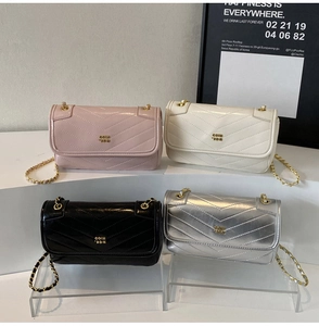 Quilted chain mini bags in pink, beige, black, and silver shown in a tiered display