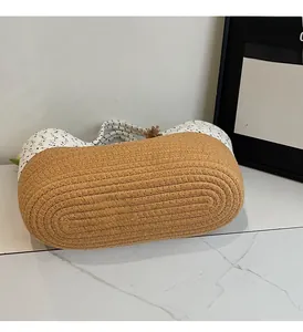 Detail of durable dual-tone cotton rope weaving and white cord handle on storage basket