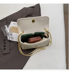 Internal view of cream quilted chain bag showing capacity for phones and wallet