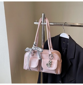 Pink glossy shoulder bag with plaid ribbon bow and silver heart charms detail