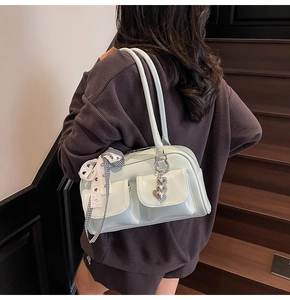 Detail of mint green bowling bag with checked ribbon bow and silver heart pendant