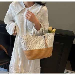 Detail of woven tote bag with contrast cream polka dots and brown straw texture