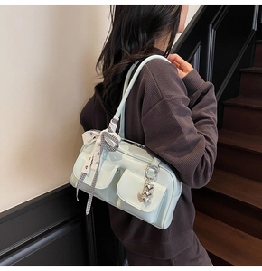 Detail of light mint green bowling bag with checkered bow and silver heart charm