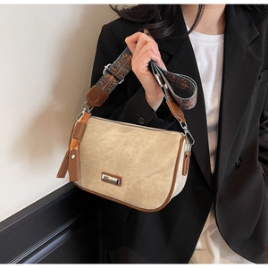 Detail of vintage khaki shoulder bag with retro jacquard strap and silver hardware