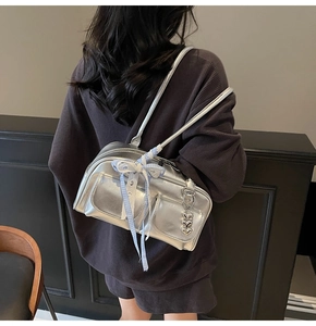 Silver metallic bowling bag featuring dual front pockets and blue ribbon detail