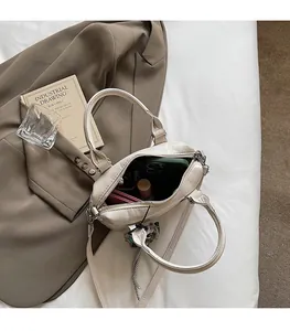 Detailed view of the beige crossbody bag interior space showing ample storage capacity