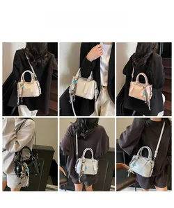 Detailed views of leather boston handbag showing charms and versatile carrying options