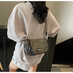 Detail of vintage canvas crossbody bag with ethnic jacquard wide shoulder strap on model