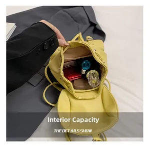 Interior view showing the large capacity of the yellow mini backpack for daily items