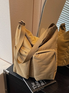 Minimalist large khaki nylon tote bag with functional front zip pockets for women