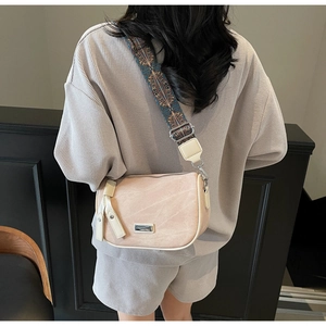 Pale pink lychee grain leather crossbody bag with wide ethnic style jacquard strap