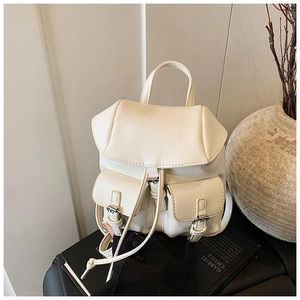 Detail of off-white lychee texture leather mini backpack with drawstring and twin pockets