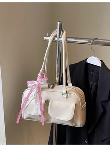 Minimalist beige bowling shoulder bag with dual front pockets and pink plaid ribbon bow