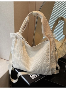 Chic beige tote bag with bubble pleated texture and lace bow detail for daily commute