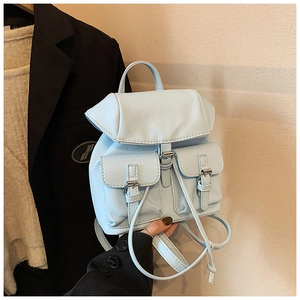 Detail of light blue pebble leather mini backpack with dual front buckled pockets
