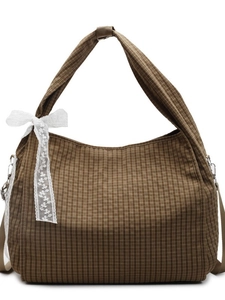 Brown plaid tote bag with white lace bow and wide shoulder strap on white background