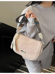 Pink faux leather pillow bag with vintage texture and colorful woven shoulder strap