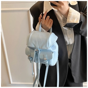 Sky blue mini backpack showing flap closure and drawstring detail with side pockets
