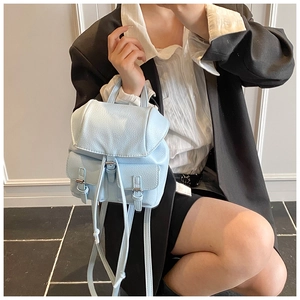 Close-up of light blue lychee pattern leather mini backpack with metal buckle detail