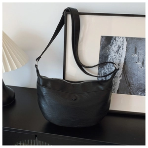 Close-up of black litchi texture faux leather hobo bag with adjustable strap and top zipper