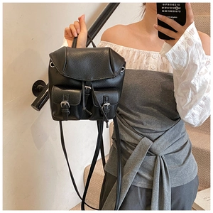 Mirror selfie showing a black pebble leather mini backpack with double front pockets
