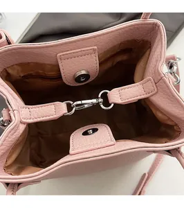 Detail view of pink lychee leather bucket bag interior with magnetic closure and zipper pocket