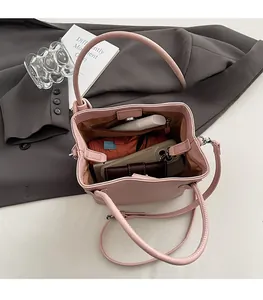 Top view of pink pebbled leather bucket bag interior showing spacious storage and zip pocket