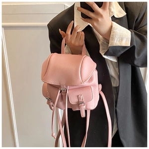 Pink lychee grain PU leather mini backpack with dual front pockets and drawstring detail