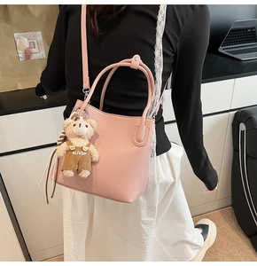 Pink lychee grain leather bucket bag with cute bear charm and detachable shoulder strap