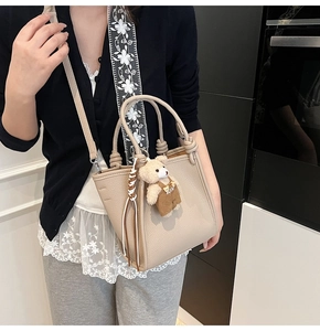Litchi pattern leather bucket bag with braided handle and floral embroidered strap