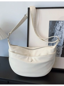 Minimalist beige dumpling shoulder bag with adjustable strap and front magnetic pocket