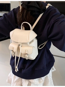 Chic off-white faux leather mini backpack with dual front pockets and drawstring closure