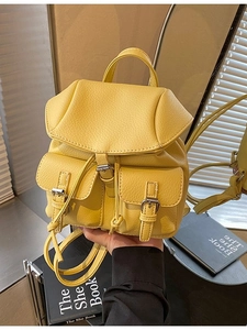 Chic yellow lychee pattern leather backpack with drawstring closure and silver buckles