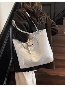 Light grey leather tote bag with cartoon embossing, heart pendant and bow decoration